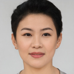 Joyful asian young-adult female with short  black hair and brown eyes