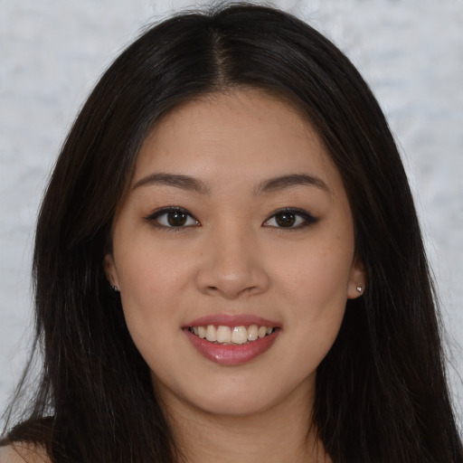 Joyful asian young-adult female with long  brown hair and brown eyes