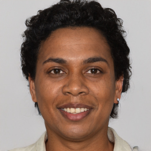 Joyful black adult female with short  black hair and brown eyes