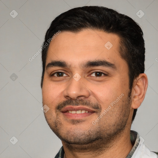 Joyful white young-adult male with short  black hair and brown eyes