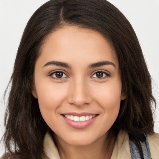 Joyful white young-adult female with long  brown hair and brown eyes