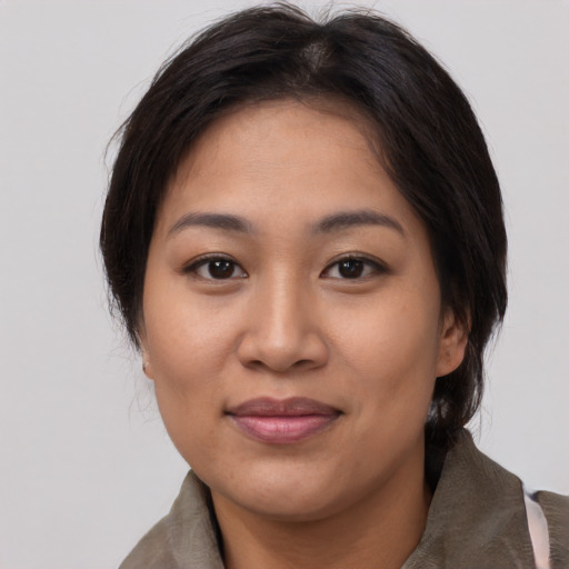 Joyful asian young-adult female with medium  brown hair and brown eyes