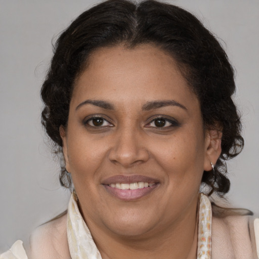 Joyful latino adult female with medium  brown hair and brown eyes