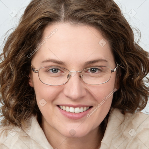 Joyful white adult female with medium  brown hair and green eyes