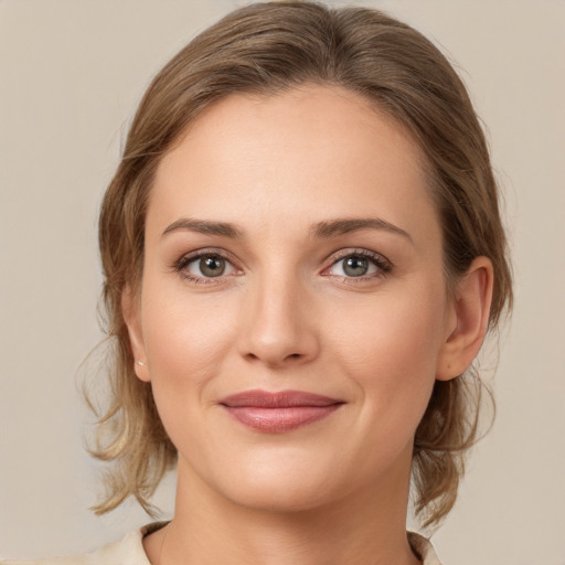 Joyful white young-adult female with medium  brown hair and grey eyes