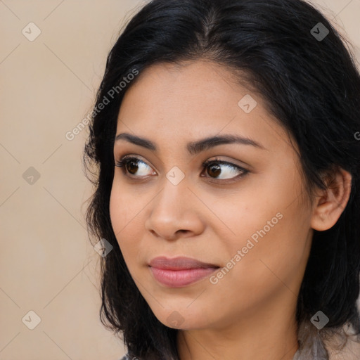 Joyful latino young-adult female with long  brown hair and brown eyes