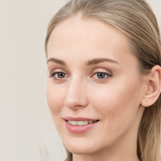 Joyful white young-adult female with long  brown hair and blue eyes