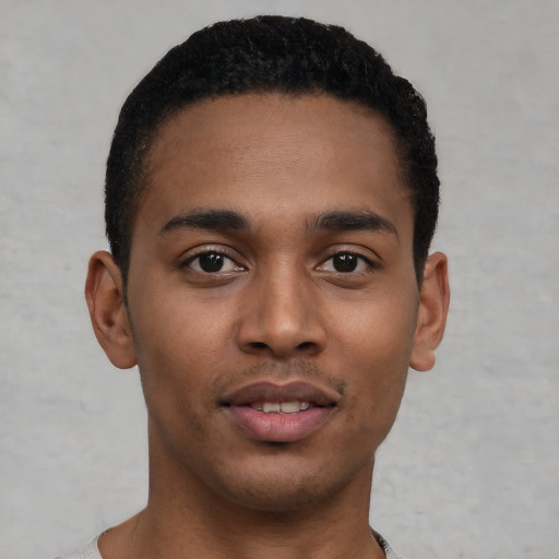 Joyful latino young-adult male with short  brown hair and brown eyes