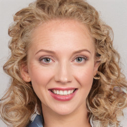 Joyful white young-adult female with long  brown hair and blue eyes