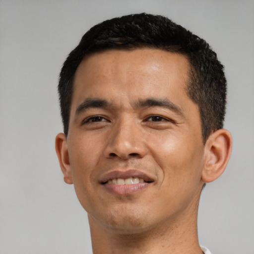 Joyful asian young-adult male with short  black hair and brown eyes