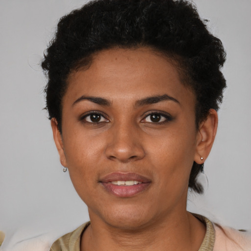 Joyful latino young-adult female with short  black hair and brown eyes