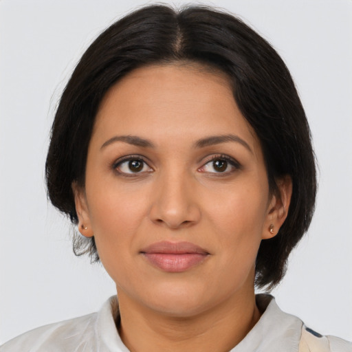 Joyful latino adult female with medium  brown hair and brown eyes