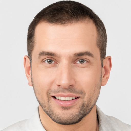 Joyful white young-adult male with short  brown hair and brown eyes