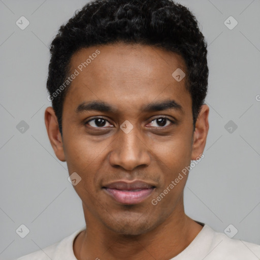 Joyful black young-adult male with short  black hair and brown eyes