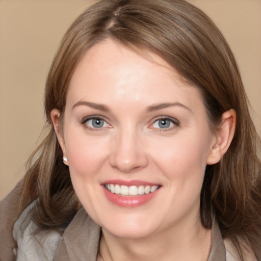 Joyful white young-adult female with medium  brown hair and grey eyes