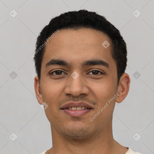 Joyful latino young-adult male with short  black hair and brown eyes