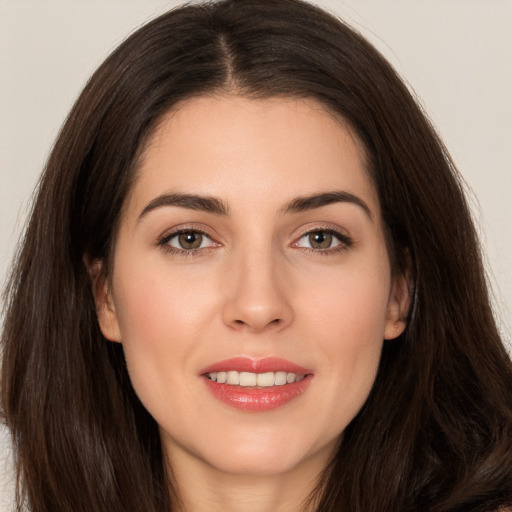 Joyful white young-adult female with long  brown hair and brown eyes