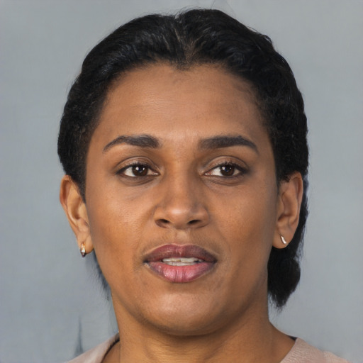 Joyful black young-adult female with short  black hair and brown eyes