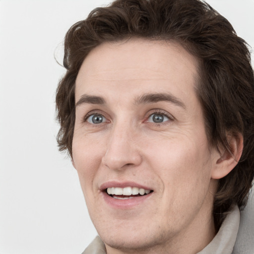 Joyful white adult male with medium  brown hair and grey eyes