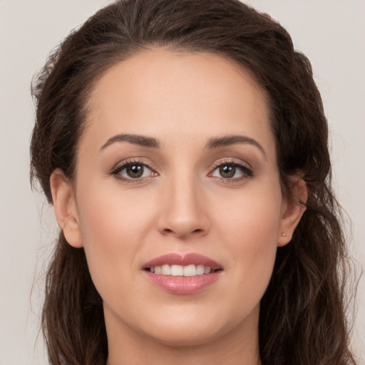 Joyful white young-adult female with long  brown hair and brown eyes