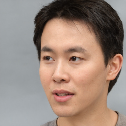 Neutral asian young-adult male with short  brown hair and brown eyes