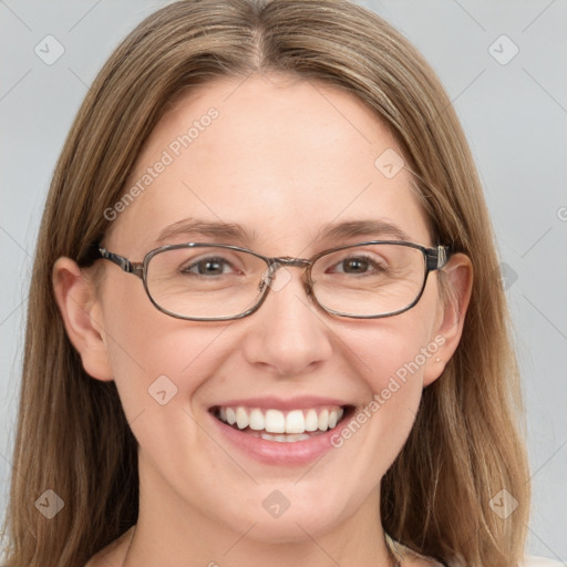 Joyful white adult female with long  brown hair and blue eyes