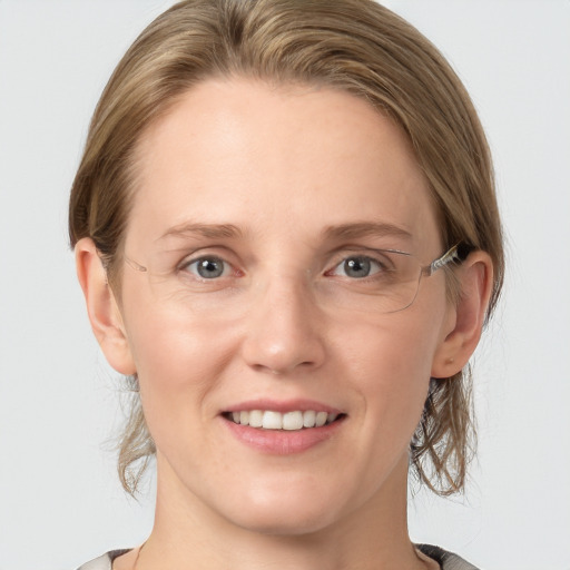 Joyful white young-adult female with medium  brown hair and blue eyes