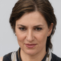 Joyful white adult female with medium  brown hair and brown eyes