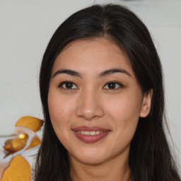 Joyful white young-adult female with long  brown hair and brown eyes