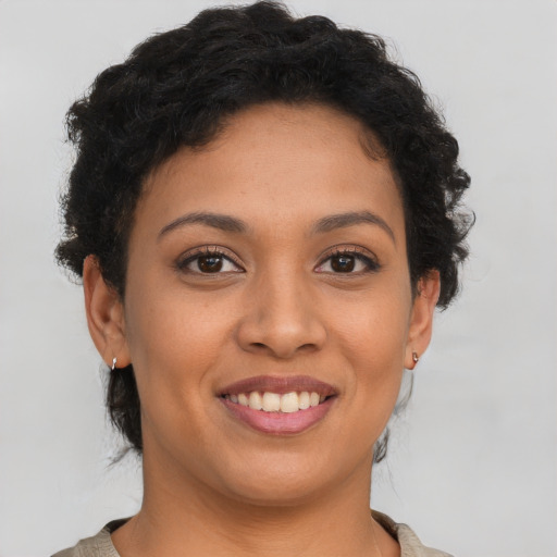 Joyful latino young-adult female with short  brown hair and brown eyes