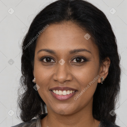 Joyful black young-adult female with long  brown hair and brown eyes