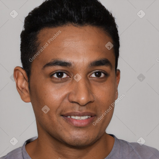 Joyful black young-adult male with short  brown hair and brown eyes