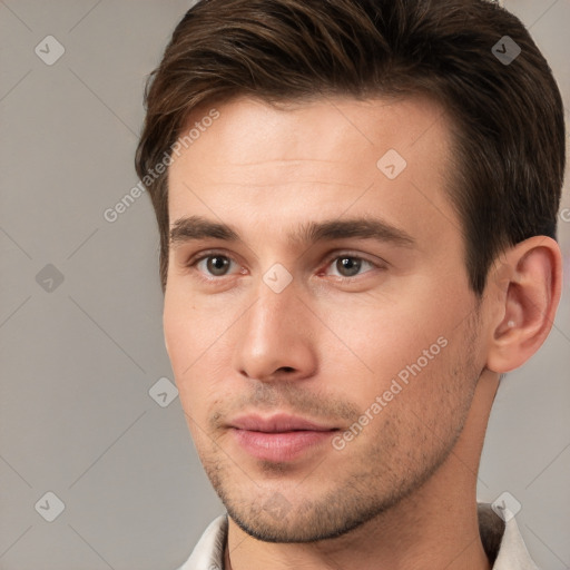 Joyful white young-adult male with short  brown hair and brown eyes