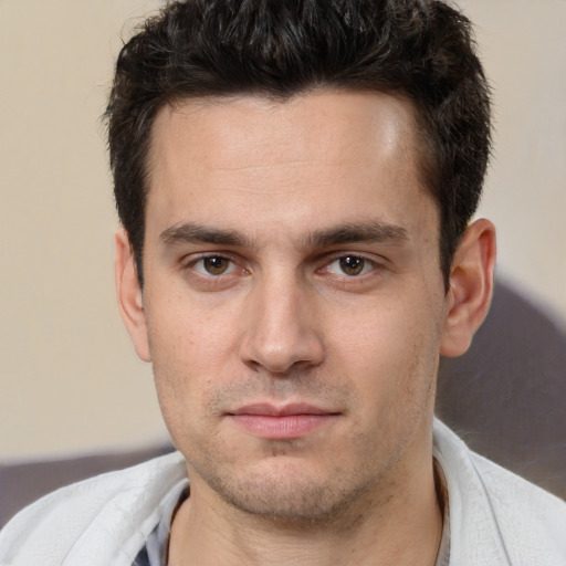 Joyful white young-adult male with short  brown hair and brown eyes