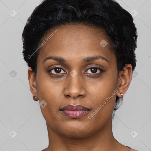 Joyful black young-adult female with short  black hair and brown eyes