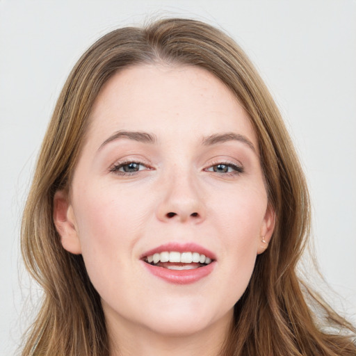 Joyful white young-adult female with long  brown hair and grey eyes