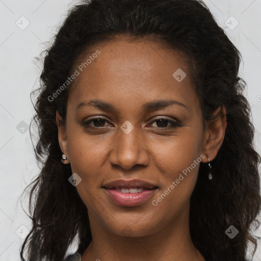 Joyful black young-adult female with long  brown hair and brown eyes