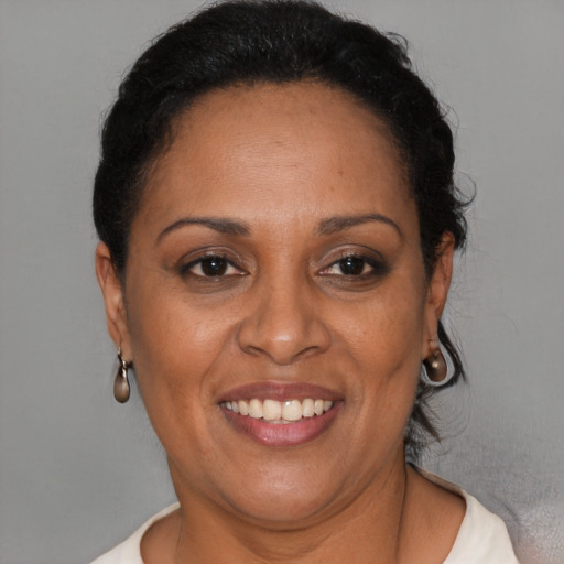 Joyful latino adult female with short  brown hair and brown eyes