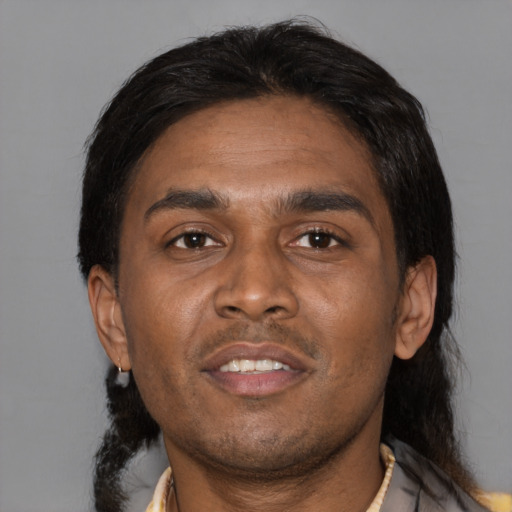 Joyful asian young-adult male with medium  black hair and brown eyes