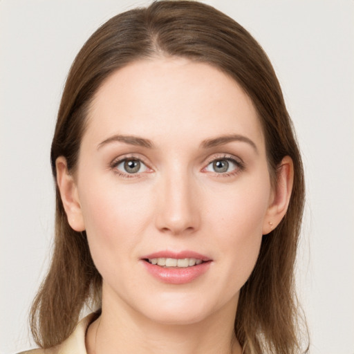 Joyful white young-adult female with long  brown hair and grey eyes