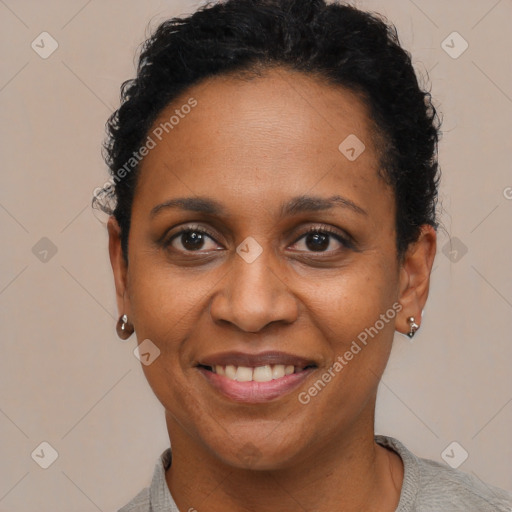 Joyful black adult female with short  brown hair and brown eyes