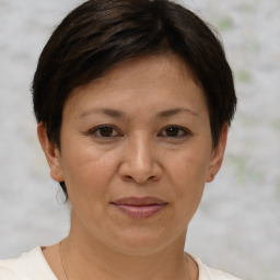 Joyful white adult female with short  brown hair and brown eyes