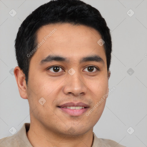 Joyful latino young-adult male with short  black hair and brown eyes