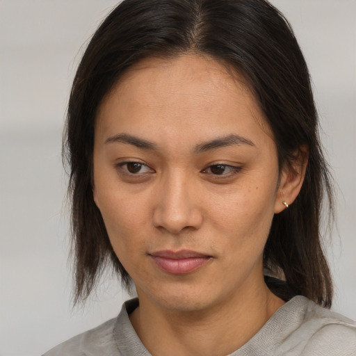 Neutral asian young-adult female with medium  brown hair and brown eyes