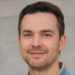 Joyful white adult male with short  brown hair and brown eyes