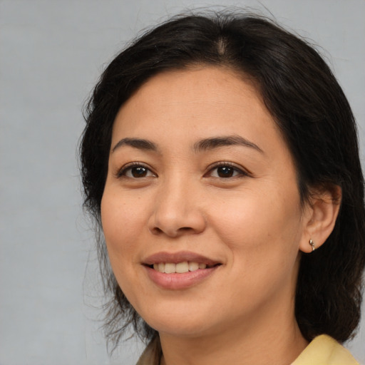 Joyful asian young-adult female with medium  brown hair and brown eyes