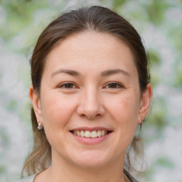 Joyful white young-adult female with medium  brown hair and brown eyes