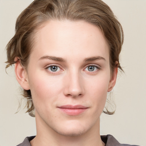 Joyful white young-adult female with medium  brown hair and blue eyes