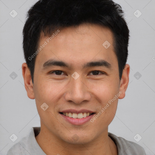 Joyful asian young-adult male with short  brown hair and brown eyes