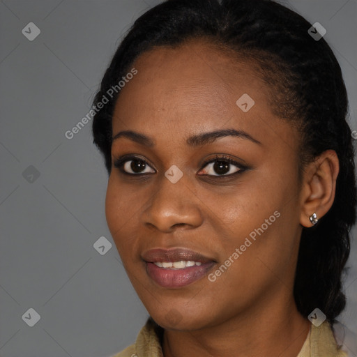 Joyful black young-adult female with long  black hair and brown eyes